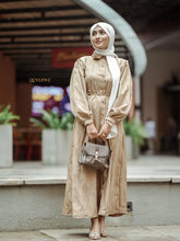 Yezwe brown textured maxi dress with button details and long sleeves, styled with a handbag